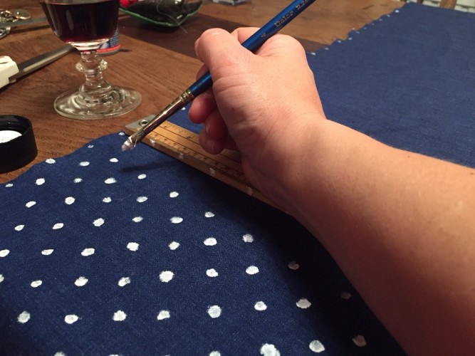 hand painting spots onto Irish Linen