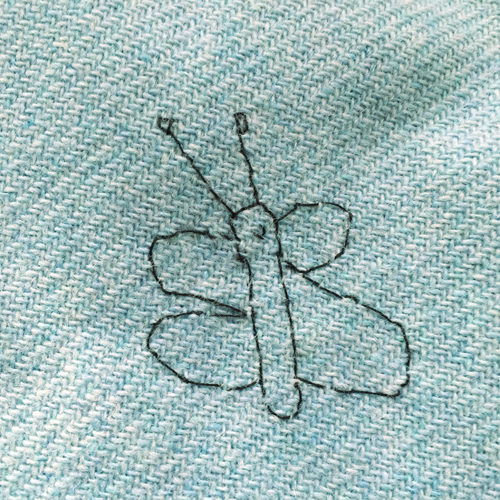 hand embroidered childre's drawings onto wool tweed skirt