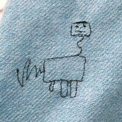 hand embroidered childre's drawings onto wool tweed skirt