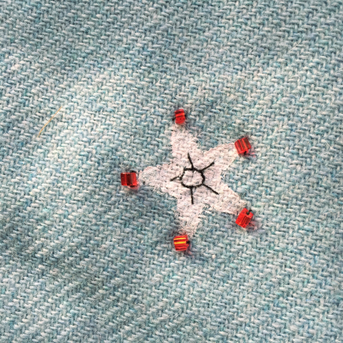 hand embroidered childre's drawings onto wool tweed skirt