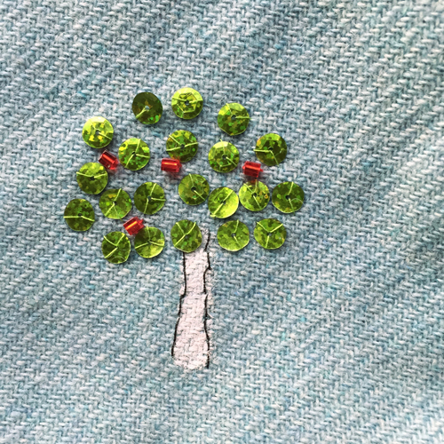 hand embroidered childre's drawings onto wool tweed skirt