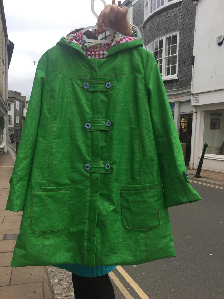 green proofed linen raincoat with pixel daisy organic cotton lining