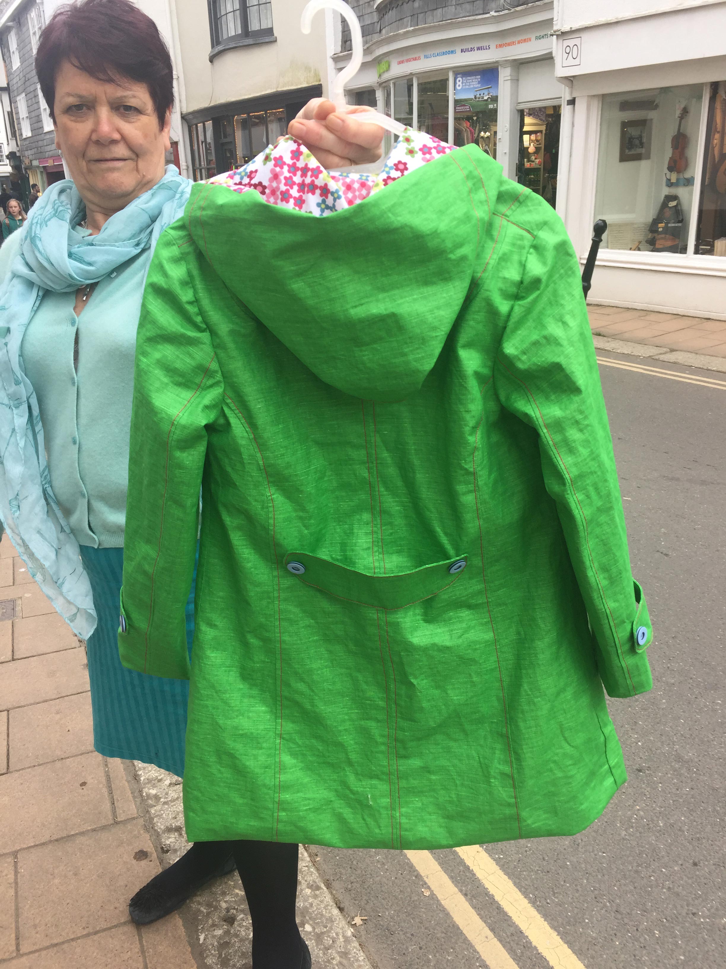 green proofed linen raincoat with pixel daisy organic cotton lining