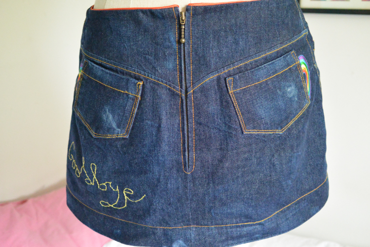 red selvedge denim mini skirt wirth rainbow patches (back view)