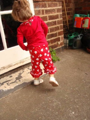 red chicken printed cotton trousers