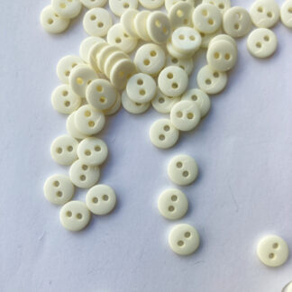 Cream two hole glossy extra small plastic button.