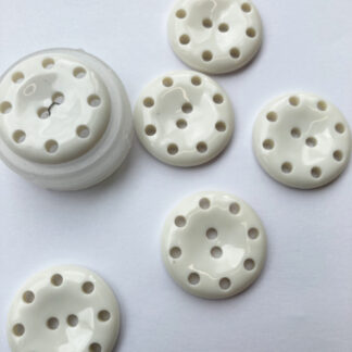 white plastic button with holes