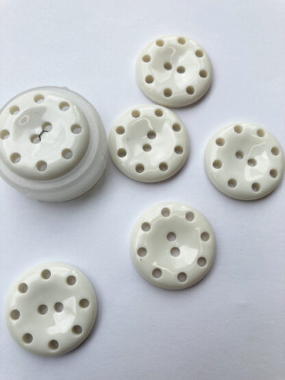 white plastic button with holes