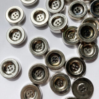 Silver vintage 1960's chunky 2 hole metal button. Due to age natural tarnishing of buttons cause colour variations