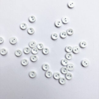 white miniscule 2 hole plastic button