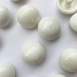 white glossy plastic ball button