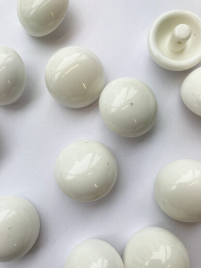 white glossy plastic ball button