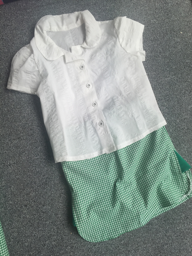 white cotton school shirt and green gingham school skorts