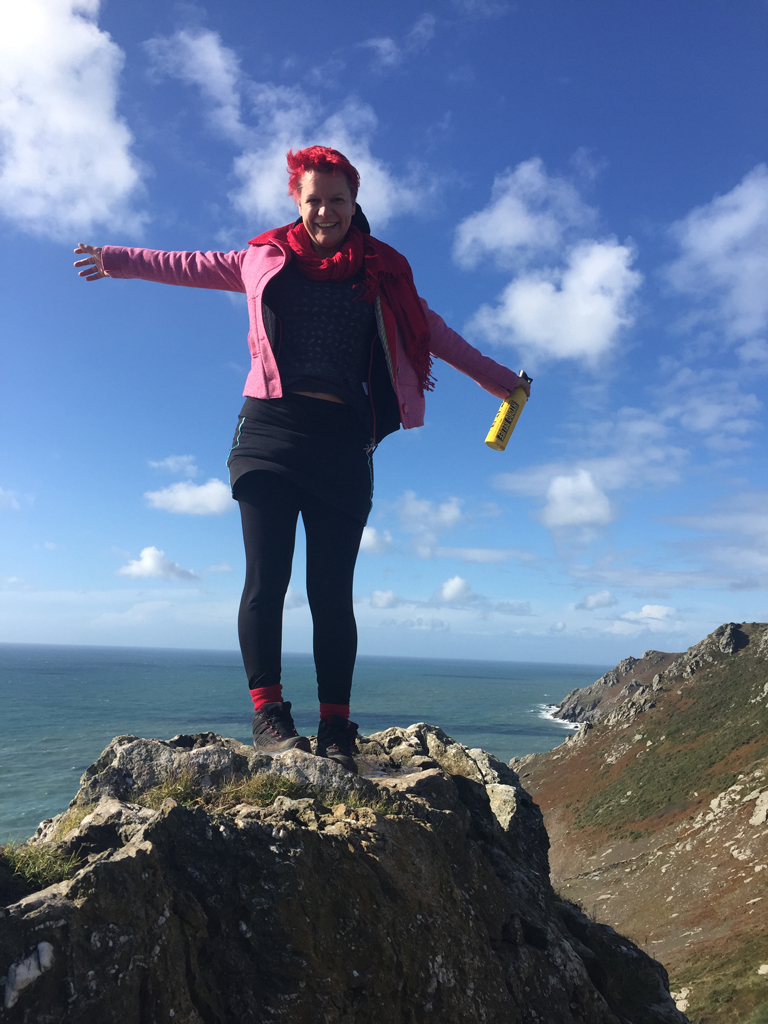 pink tweed coat on top of the devon cliff