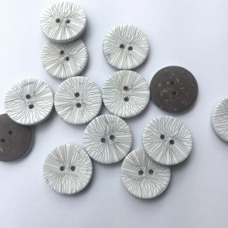 white sgraffito patterned wooden button