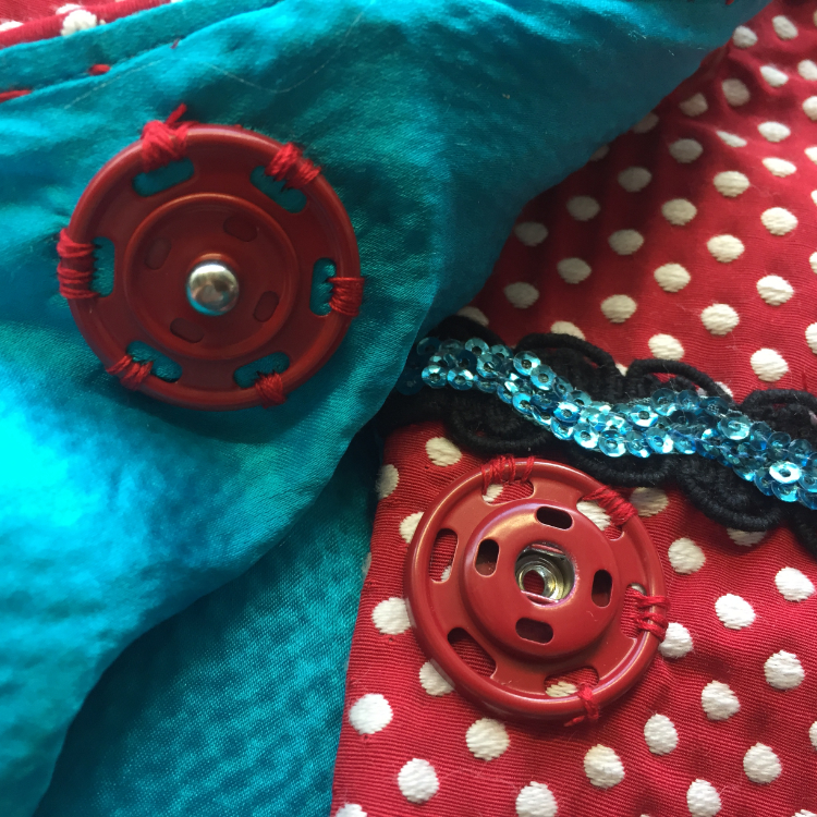 Jacket detail: Giant red sew on snap fastener, electric blue turquoise silk seersucker satin, sequinned rickrack and gimp braid. 