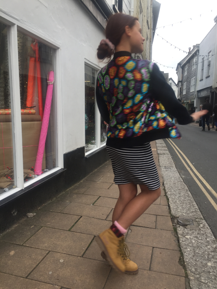 doing a twirl in multicolour sequined bomber jacket