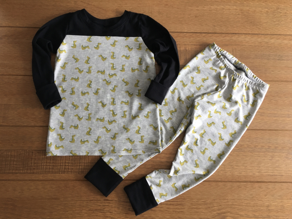 glow in the dark fire breathing dragons print pj's with black contrasting cuffs, sleeves and yoke