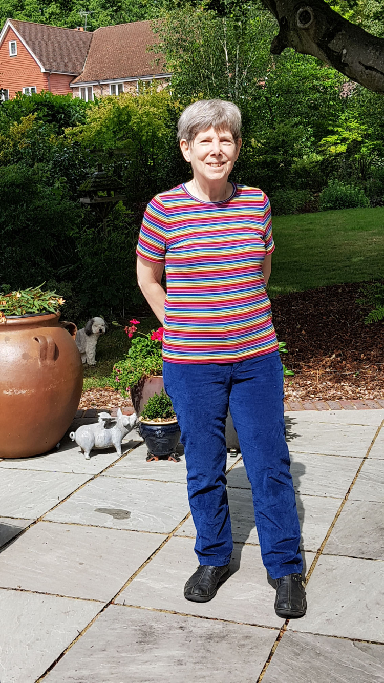 sally standing on patio wearing stripey cotton lark tee and crosscut stretch corduroy jeans