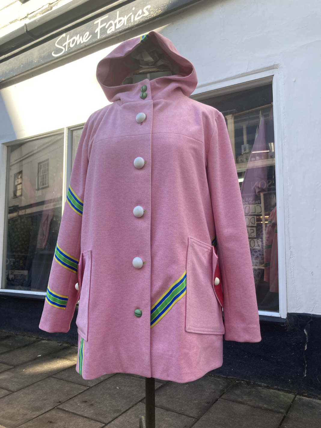 KElly Anorak made up in pink sorona fibre coating and trimmed with grosgrain ribbon