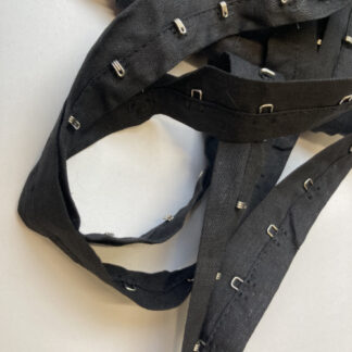 Black hook and eye fasteners on 100% cotton tape, hooks every 25mm