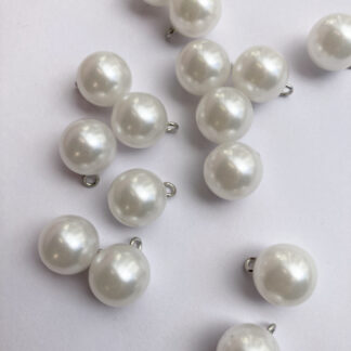 White pearl effect round plastic button on shank