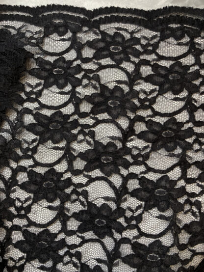 Black 55% Polyamide 45% Cotton corded floral Lace. Double scalloped selvedges