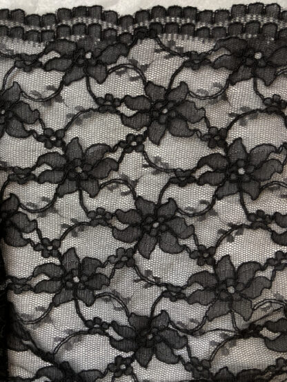 Black 55% Polyamide 45% Cotton corded floral Lace. Double scalloped selvedges