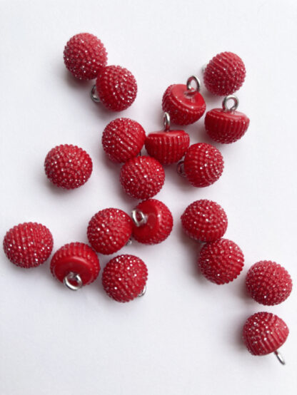 Red sparkly plastic dome button on shank