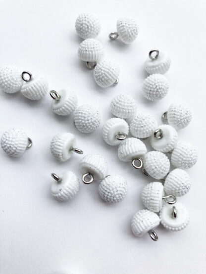 White sparkly plastic dome button on shank