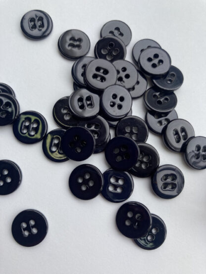 Black faux shell glossy plastic 2 hole flat button
