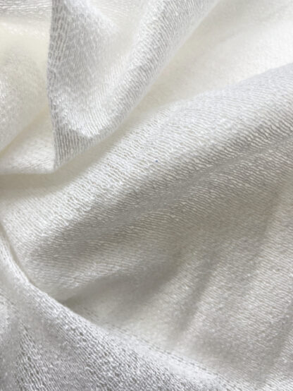 ivory weft insertion fusible knit interfacing. 78% viscose, 22% polyester.