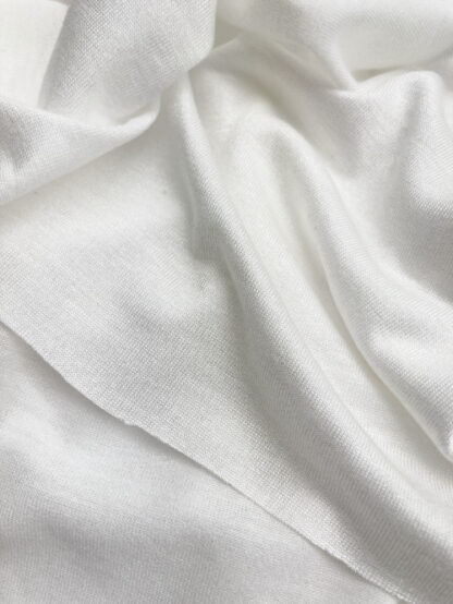 Ivory  knitted Jersey 100% Viscose medium / heavy iron-on interfacing. Use for stabilising heavier jerseys and knits, and anything which needs a substantial stretch interfacing 
