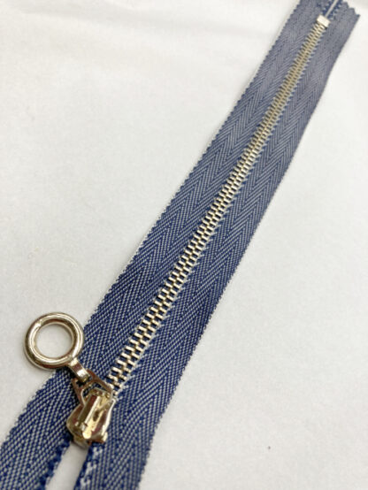 Denim jeans twill tape closed end zip with gold coloured metal teeth and ring puller. Suitable for pockets, pouches and bags