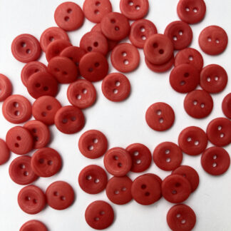 Red corozo (Tagua nut/vegetable ivory) 2 hole wooden button with thumb dent