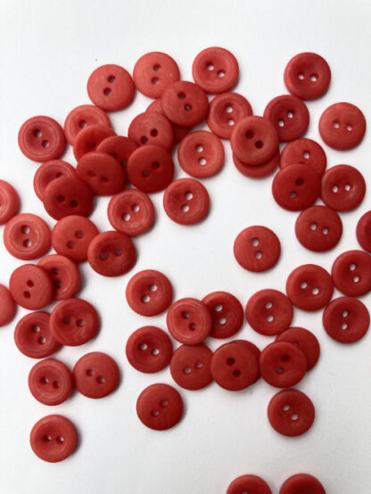 Red corozo (Tagua nut/vegetable ivory) 2 hole wooden button with thumb dent