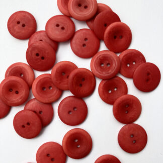 Red corozo (Tagua nut/vegetable ivory) 2 hole wooden button with thumb dent