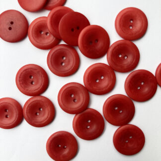 Red corozo (Tagua nut/vegetable ivory) 2 hole wooden button with thumb dent