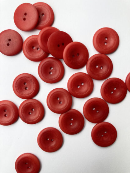 Red corozo (Tagua nut/vegetable ivory) 2 hole wooden button with thumb dent